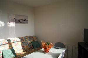 a living room with a couch and a table at Simple Asile in Mers-les-Bains