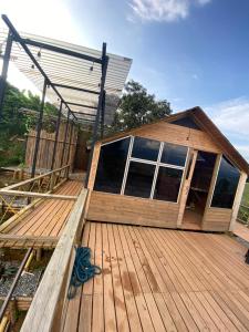 a large wooden deck with a house on it at Glamping Resort Jonico Finca in Chinchiná