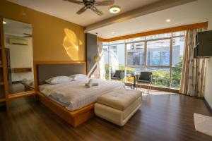 a bedroom with a large bed and a large window at Cozy Gurney Georgetown Private Apartment Penang in George Town