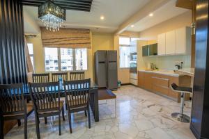 a kitchen and dining room with a table and chairs at Cozy Gurney Georgetown Private Apartment Penang in George Town