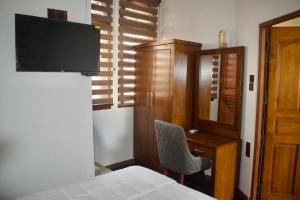 a bedroom with a bed and a desk and a chair at Vivid Colombo in Colombo