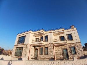a building in front of a blue sky at ELEGANT HOUSE Cappadocia in Göreme