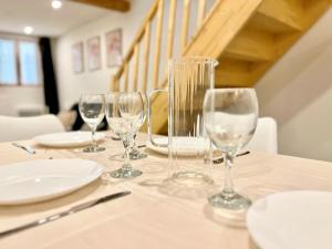 a table with wine glasses and plates on it at O Nid'Istres - Centre Historique, Spacieux Studio Duplex, Wifi, 4 personnes in Istres