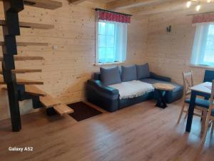 a living room with a couch and a table at Wilkowiana in Wilkowice +11 photos