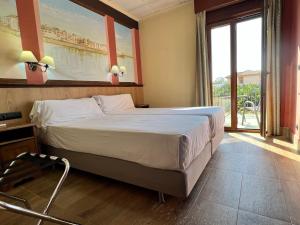 Postel nebo postele na pokoji v ubytování Hotel Pinomar
