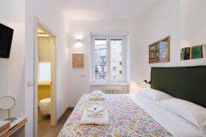 a bedroom with a bed with towels on it at H7 in Lido di Ostia