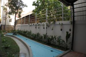 a swimming pool in the side of a building at Mowin Boutique Hotel & Residence in Phnom Penh