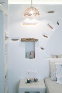 a room with a couch and a chandelier at Villa Amalia at Campos Antiparos in Andiparos