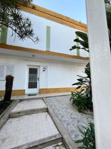 a white building with a door on it at B&B La Mendoza in San Miguel de Tucumán
