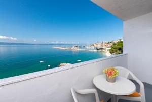 a balcony with a table and a view of the water at Apartments Luka in Krilo