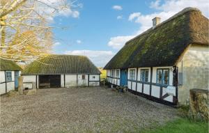 an old house with a thatched roof and a yard at Pet Friendly Home In Humble With Wifi in Humble +10 photos