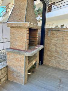 an outdoor kitchen with an outdoor brick oven at The SeaSide Villas in Nikiti
