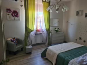 a bedroom with a bed and a window with curtains at Ai piedi del Centro Storico in Castiglione del Lago