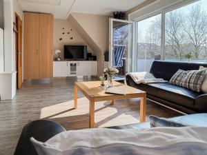 a living room with a couch and a table at FeWo Oldeoog OG - Horumersiel in Horumersiel