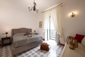 a bedroom with a bed and a bag on the floor at Boutique Gimagì in Amalfi