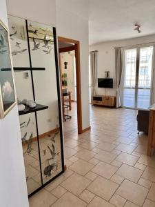 a living room with a hallway with birds on the wall at Appartamento Nuvola Bianca 1 in Cesenatico