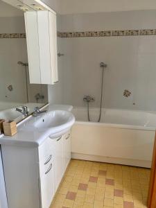 a bathroom with a sink and a bath tub at Appartamento Nuvola Bianca 1 in Cesenatico +9 photos