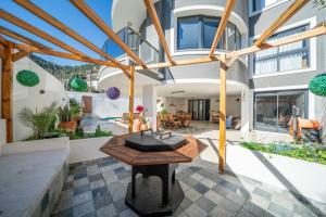 a house with a wooden table in the middle of a courtyard at LİV Villa in Marmaris