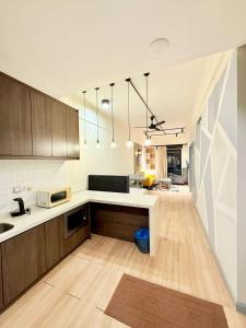 a kitchen with wooden cabinets and a white counter top at Elements Service Suites Time Square kl in Kuala Lumpur