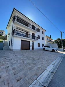 a white car parked in front of a building at Apartma Seaside in Koper