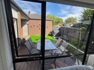 a patio with a table and chairs on a deck at The hidden retreat in Doreen