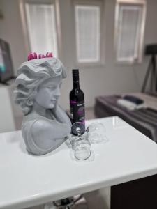 a statue of a woman holding a bottle on a table at M and M Apartment in Ohrid