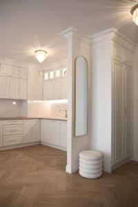 a white bathroom with a sink and a mirror at Apartament w centrum miasta- Central Park in Ciechanów
