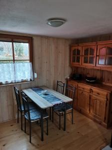 a kitchen with a table and chairs in a room at Ferienhaus Mühlberg 4 in Braunschwende