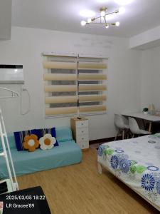 une chambre avec un lit, un bureau et une table dans l'établissement Eman's Crib, à Cagayán de Oro