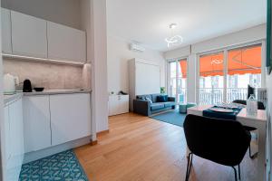 a kitchen and living room with a table and chairs at LovelyHouseBraida in Milan