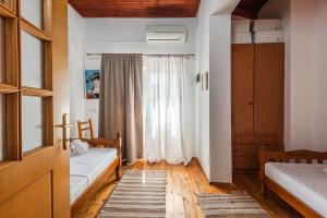 a bedroom with two beds and a window at 'Easy Steps' Guesthouse - Room 1 - Pro Bono in Shkodër