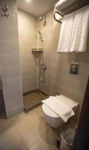 a bathroom with a shower with a toilet and a sink at La Rosa Empire Hotel-Ain Sokhna in As Suways
