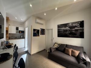 a living room with a couch and a kitchen at Scugnizzo Apartment in Naples