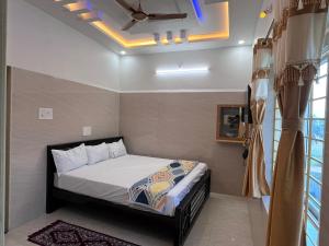 a bedroom with a bed and a ceiling fan at SRI HARI RESIDENCy in Kanipakam