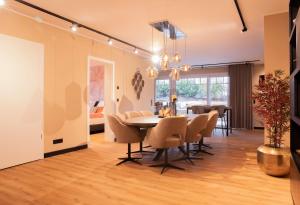 a dining room and living room with a table and chairs at Residence Vivaldi in Winterberg