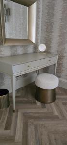 a white desk with a chair and a mirror at 2 Bedroom Sofa bed in livingroom Castle View 1st floor sleeps 6 in Edinburgh +109 photos