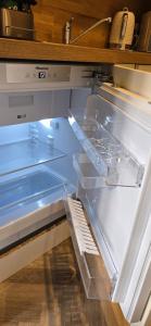 an empty refrigerator with its door open in a kitchen at 2 Bedroom Sofa bed in livingroom Castle View 1st floor sleeps 6 in Edinburgh