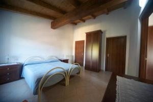 a bedroom with a bed and two chairs in it at Al Vecchio Convento Mare e Monti in Ortonovo