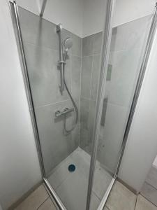 a shower with a glass door in a bathroom at T2 dans villa plain-pied avec parking privé in Canet-en-Roussillon +31 photos