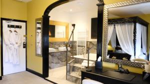 a bathroom with a large mirror and a sink at St Hildas Complex in Hinderwell