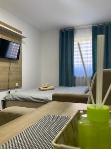 a hotel room with two beds and a table with a table sidx sidx at Apartmani AVLIJA in Ribare