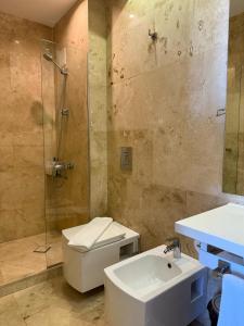 a bathroom with a shower and a toilet and a sink at Boutique Hotel Kanyon in Sofia +23 photos