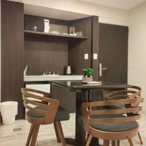 a kitchen with a wooden table and chairs at Departamentos Arenales in Viedma