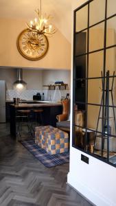 a dining room and kitchen with a clock on the wall at St Hildas Complex in Hinderwell