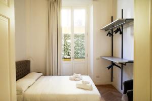 Postel nebo postele na pokoji v ubytování PORTA NUOVA SUITES