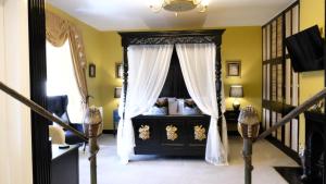 a bedroom with a bed with a canopy at St Hildas Complex in Hinderwell
