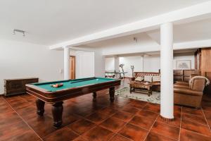 a living room with a pool table and a couch at Viana Beach Surf House in Viana do Castelo
