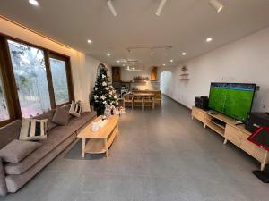 a living room with a christmas tree and a television at Én Nhỏ Homestay Sa Pa in Sa Pa