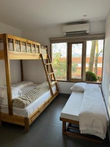 two bunk beds in a room with a window at Én Nhỏ Homestay Sa Pa in Sa Pa