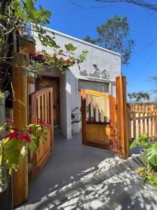 a house with a wooden gate and a porch at Én Nhỏ Homestay Sa Pa in Sa Pa